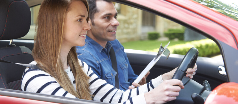 Learner with examiner in the car both looking ahead