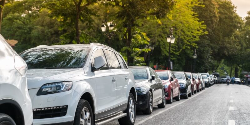 Row of cars parked along the side of the road