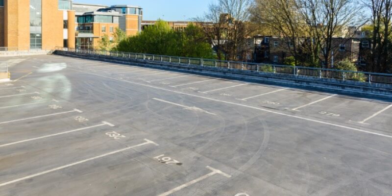 Empty car park with marked bays on the ground