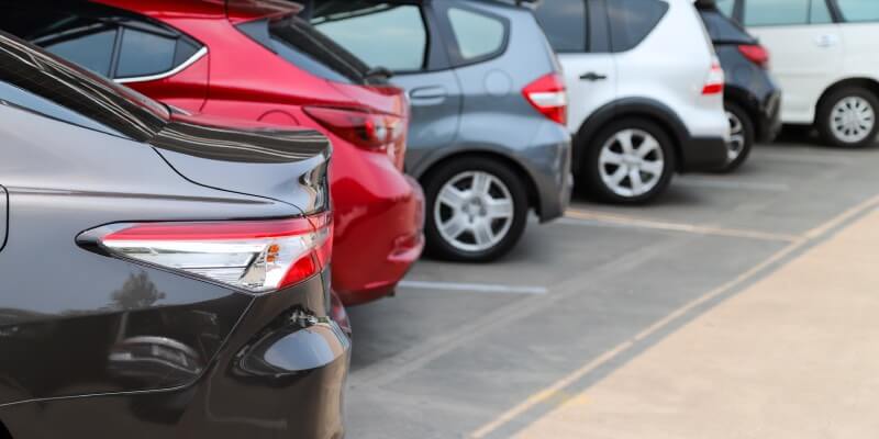 Row of cars forward bay parked into spaces