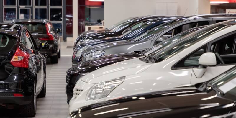 Multiple different types of cars in a car showroom