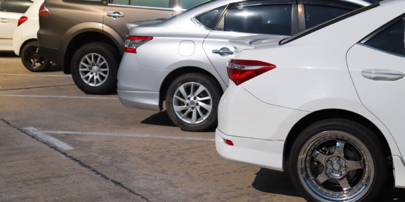 Row of cars parked forwards into spaces